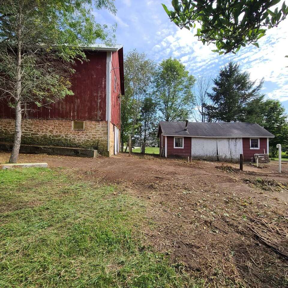 Barn lot graded to smooth bare soil after brush and debris were cleared